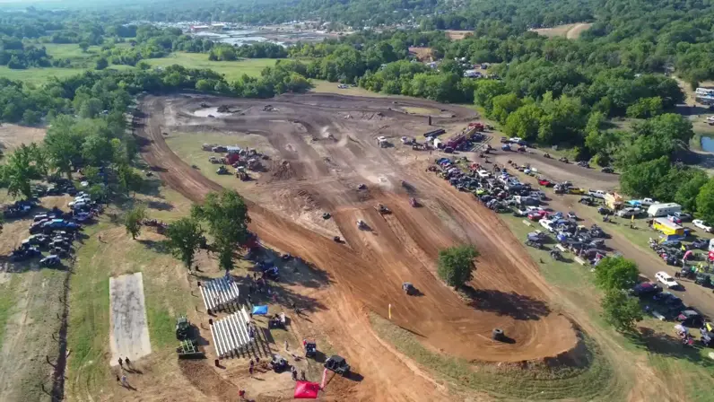 Aerial view of the park with rigs and campers parked around the track